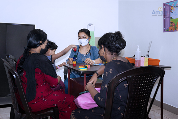 Amala Hospital image of Child Development Clinic – Dr.Parvathi R & Dr.Riya Lukose assessing the child.
